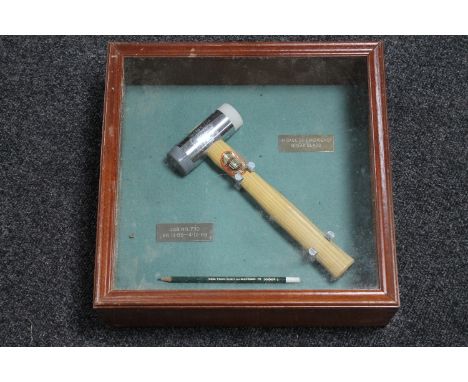 A wooden display box with presentation hammer and pencil 
