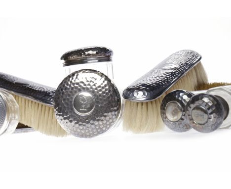 SILVER BACKED PART VANITY SETcomprising four brushes, London 1903, all with hammered pattern to silver backs, along with four