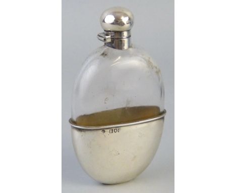 A Victorian hip flask, of oval clear glass form with hinged domed top and removable beaker cover, 15.5cm high London 1898