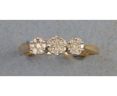 A diamond ring, comprising three flowerheads of seven diamonds set in row on 9ct gold shank, size R