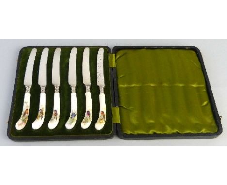 A set of six Royal Worcester tea knives, each with ceramic pistol shaped handles painted with a different bird, signed W. Pow
