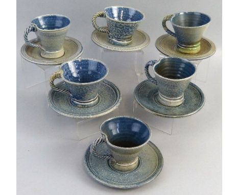 Jane Hamlyn, a matched set of six salt glazed stoneware cups and saucers, each of tapering form with rope twist handle in gre