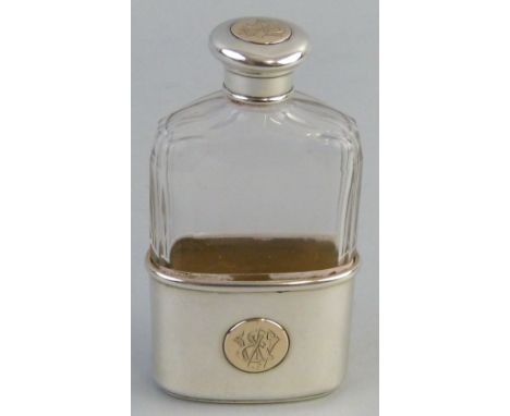 A Victorian hip flask, the facetted clear glass body with screw top and removable half cover/beaker each inset with a monogra