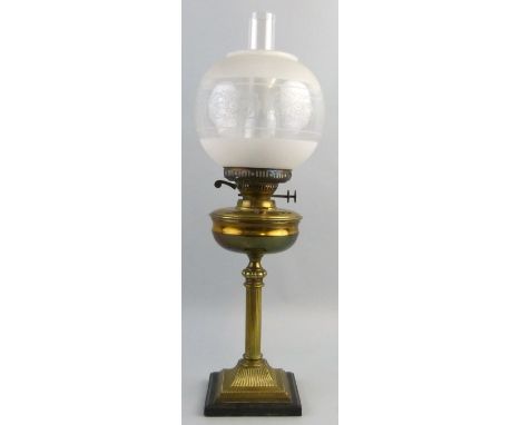 A table oil lamp, with ebonised wooden square base brass reeded column stem and reservoir, duplex burner, frosted and clear g