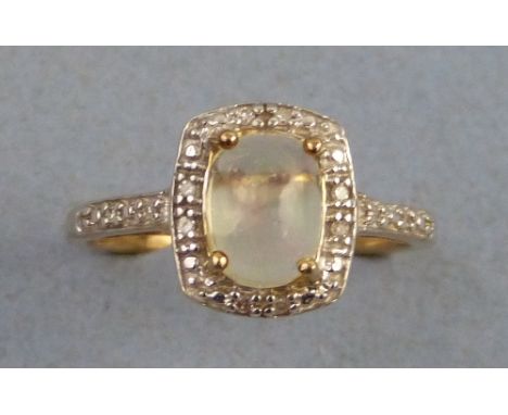 An opal and diamond ring, having central oval opal in a rounded oblong diamond frame with diamond inset shoulders on 9ct gold