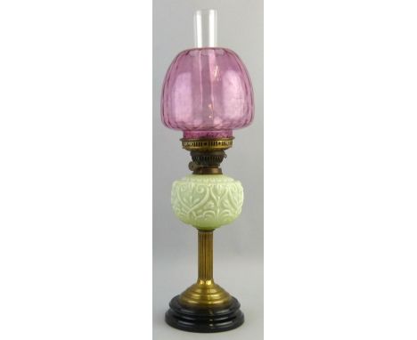 A Victorian table oil lamp, with black glazed ceramic base, brass reeded column stem, moulded opaque glass reservoir, duplex 