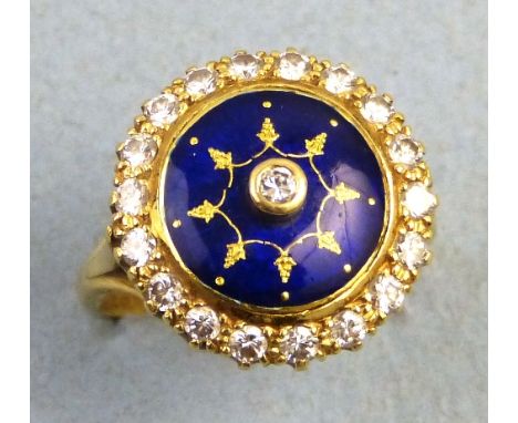 A diamond ring, with central raised solitaire stone on a blue enamel ground bordered by nineteen diamonds, total 0.76ct, on 1