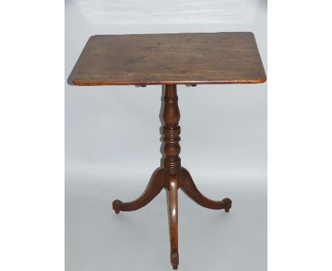 A 19th century mahogany tripod table, having oblong tilt top on ring turned stem the downswept legs terminating in block feet