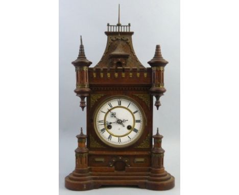A late 19th century Junghans mantel clock, with brass eight day movement striking on a single gong the circular enamel dial w