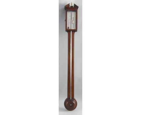 A 19th century mahogany stick barometer, the broken arched pediment with central turned brass finial over an oblong glazed do