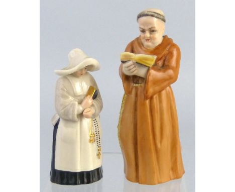 A pair of Royal Worcester candle snuffers, as a monk reading a book, 12cm high and a nun carrying a book, 10cm high, both dat