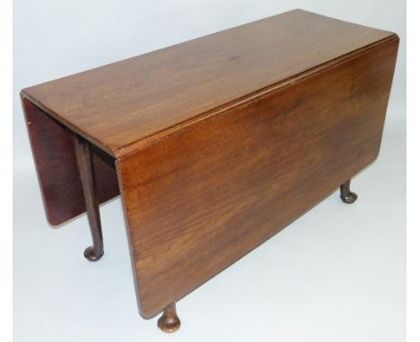 A Georgian mahogany gate-leg dining table, with two rounded oblong drop leaves and four tapering legs with pad feet, 121.5 wi
