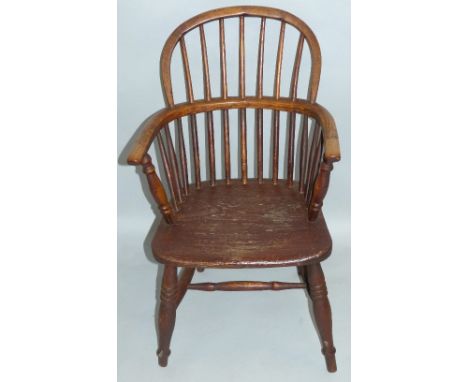 An oak and elm Windsor armchair, having low hoop stick back, baluster end arm supports and turned legs joined by H-stretcher,