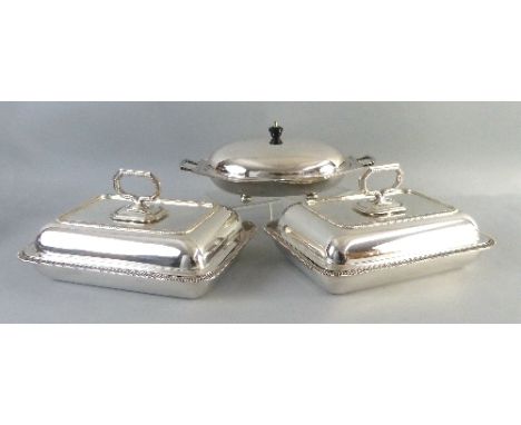 A pair of entree dishes and covers,  each of rounded oblong form with gadrooned rims and removable ring handles, 28cm wide an
