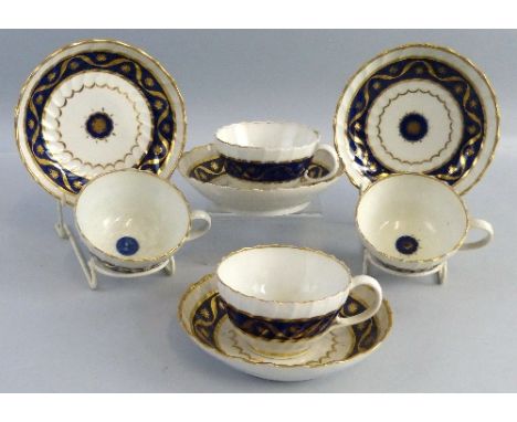 A set of four 19th century Worcester cups and saucers,  each of typical wrythen fluted form decorated with band designs in bl