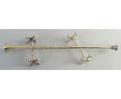 An early 20th century hunting horn, 30cm, Chester 1912, 1.3ozs displayed on a pair of plated knife rests