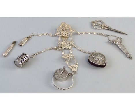 A chatelaine, the belt hook with pierced and scrolling cherub mount, hung with three further graduated cherub mounts terminat