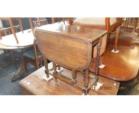 An oak miniature gate leg table