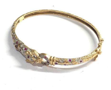 9ct gold leopards head ruby and diamond hinged bangle measures approx 6.5cm by 5.3cm weight 10.6g 