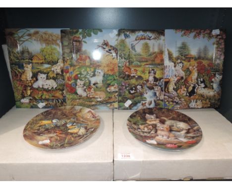 A selection of display plates and ceramic wall tiles with cat and kitten imagery