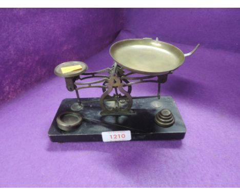 A set of jewellery or chemist balance scales with graduated weight set