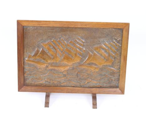 An Art Deco oak and copper mounted fire screen, decorated with scenes of sailing ships, 96cm wide