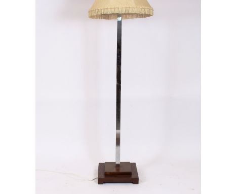 An Art Deco design chrome standard lamp, raised on a square stepped mahogany base with tassel shade