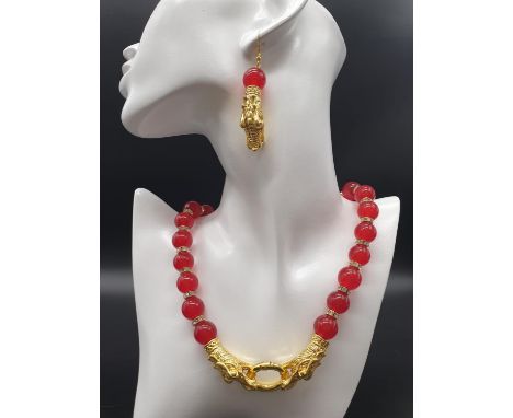 A Chinese red jade and gold filled dragons necklace and earrings set in a presentation set. Necklace length: 50 cm, earrings 