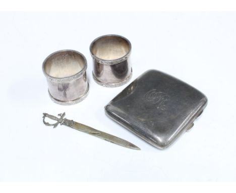 A collection of silver and white metal items to include a Birmingham silver cigarette case, two white metal napkin rings, and