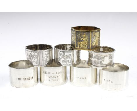 Seven silver napkin rings with various hallmarks and a brass napkin ring with Egyptian motifs,  (8) 
