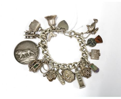 Vintage silver charm bracelet with a quantity of charms to include a Edinburgh Castle, Aladdin's lamp and a thistle with colo