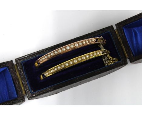 Two late 19th / early 20th century unmarked yellow metal and seed pearl bracelets, contained within the original fitted box, 