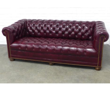 Leather chesterfield sofa, with brass studs and bun feet, 197 x 72 x 57cm. 