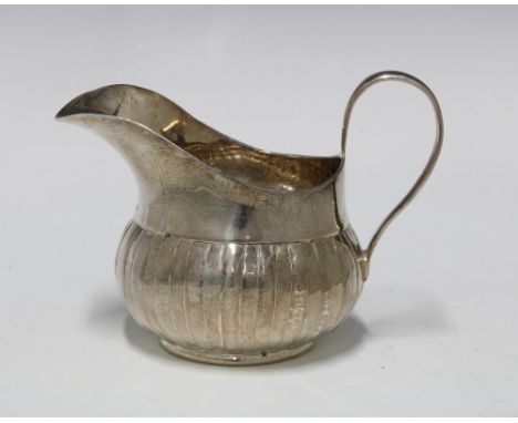 George III Irish silver cream jug, with fluted base, Dublin 1760, 9cm high 