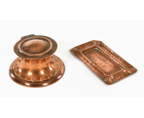 A small Arts & Crafts planished copper Capstan form inkwell and a small tray.  Length 18 cm. CONDITION REPORT: The ink cap st