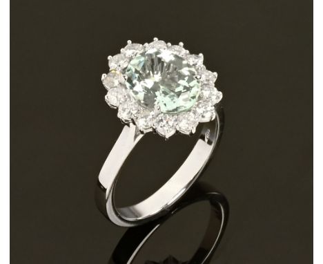 An 18 ct gold aquamarine and diamond cluster ring, aquamarine +/- 2.21 carats, diamonds +/- .72 carats.  Size N/O (see illust