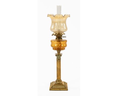 A Victorian brass Corinthian oil lamp, double wick with flared glass shade.  76 cm high to include glass chimney.