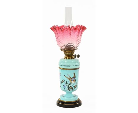 A Victorian brass and blue opaline glass oil lamp, double wick with cranberry glass flared shade.  60 cm high including glass