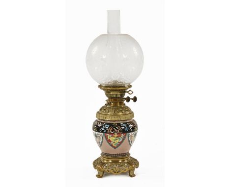 A Victorian porcelain and brass oil lamp, double wick with champleve style decoration, with globular etched shade.  55 cm hig