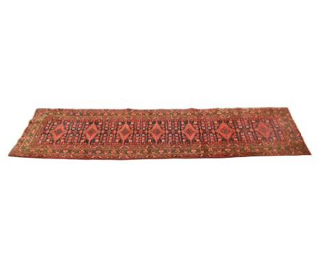 A hand knotted early 20th century Persian Heriz carpet, 4.45 m x 1.10 m (see illustration).