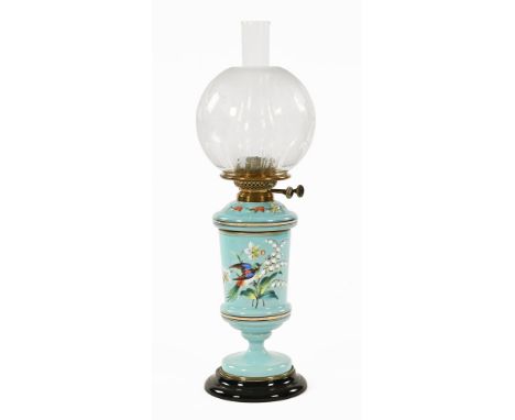 A Victorian brass oil lamp, with bird and flower decoration on blue opaline glass column, with globular etched shade.  60 cm 