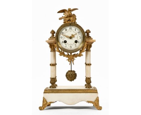 An early 20th century mantle clock, in the French Empire style with alabaster columns on a rectangular base, eight day striki