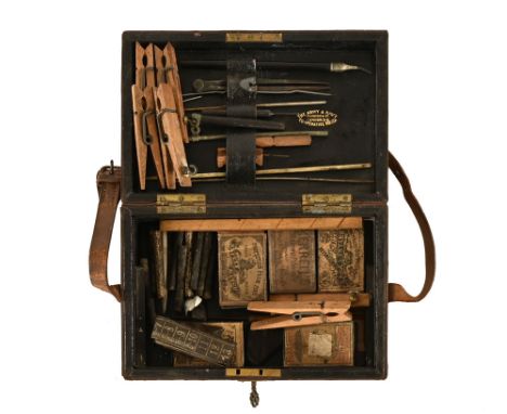 An Army &amp; Navy leather bound artist box containing black lead, various clothes pegs, scribes etc.  Width 21 cm.