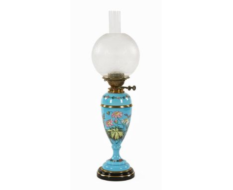 A Victorian brass oil lamp, with blue and floral decorated opaline glass column, double wick with globular etched shade.  69 