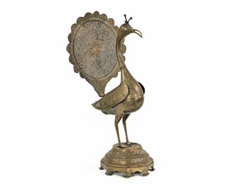 A large Persian pierced brass peacock on stand (AF).  Height +/- 65 cm. CONDITION REPORT: The comb has a loss.  The beak has 