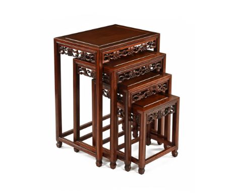 A set of 20th century teak Chinese style rectangular occasional tables, with pierced fretwork decoration and glass top.  Larg