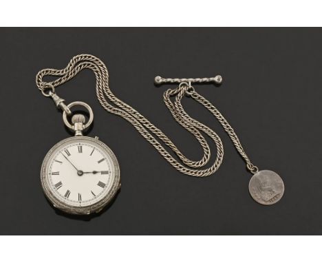 A silver foliate engraved fob watch, knob wind with Albert chain with T bar and four pence piece.  Diameter 36 mm. CONDITION 