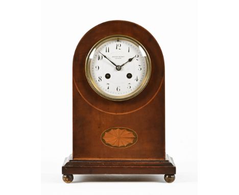 An Edwardian inlaid mahogany mantle clock by Winsor Bishop Norwich.  Height 29 cm, width 20 cm.