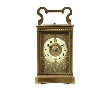 An Edwardian brass carriage clock, with repeat mechanism and two train movement striking on a gong.  Height excluding carryin