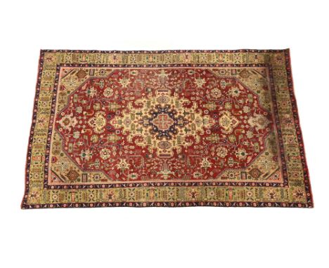 A Persian design carpet, principal colours red, beige, blue, yellow and green.  250 cm x 200 cm.